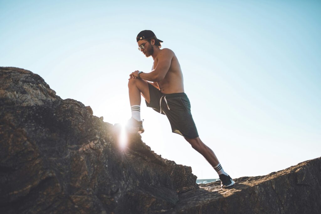 Beautiful man training and do stretching outdoor